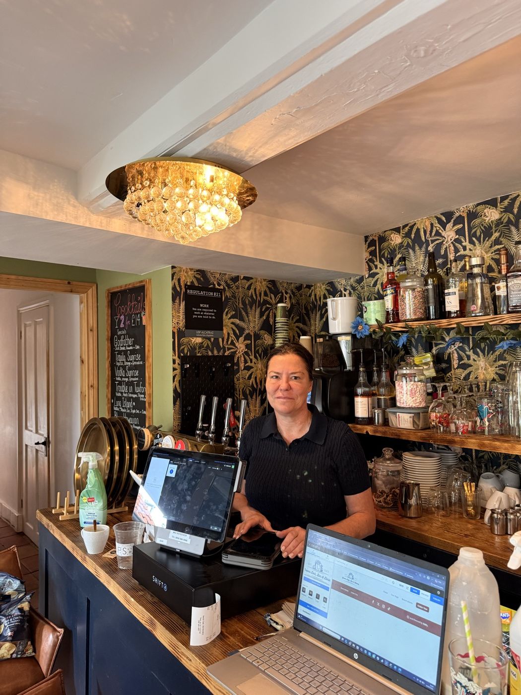 A cocktail bar counter with an iPad till and card reader