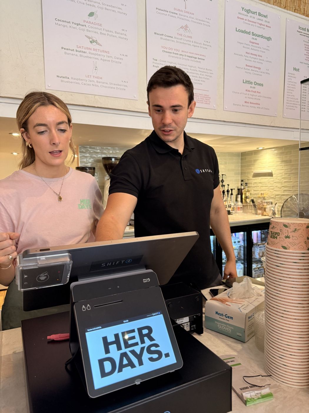 Staff being trained on a new till during service