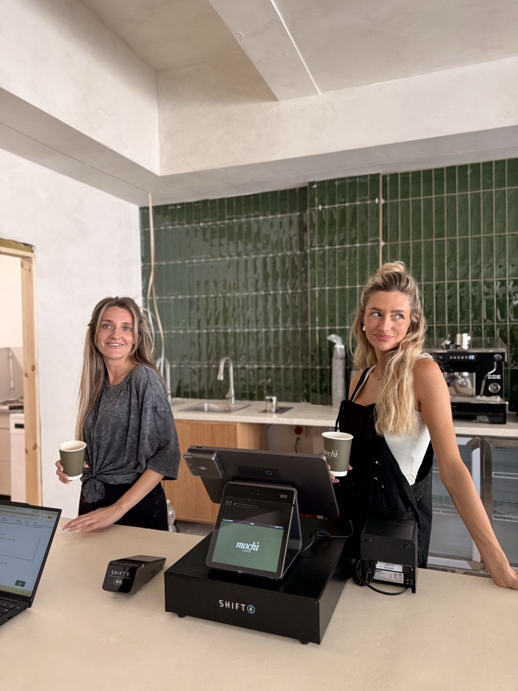 Two owners behind the counter of their café in Mansfield