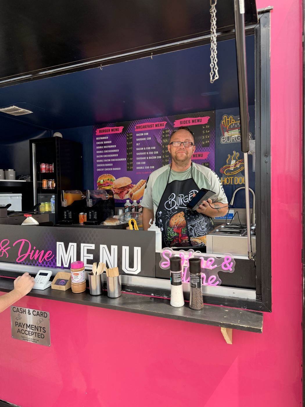A street food trailer taking a card payment at the hatch