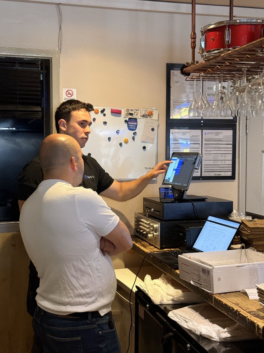 Installing and training staff on a new till system behind a bar